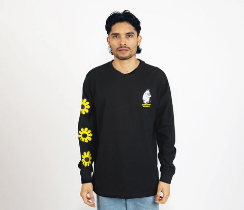 1. Unisex black Moomintroll's Flower longsleeve shirt worn by male model, featuring yellow floral sleeve design and Moomin logo, studio setting