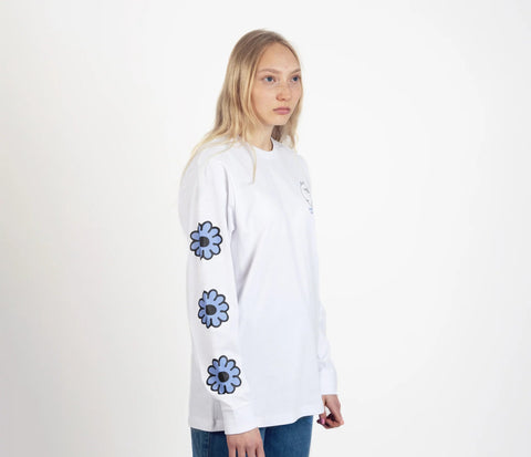 4. Unisex white Moomintroll's Flower longsleeve shirt worn by female model, side view with blue floral sleeve design and cuffrib