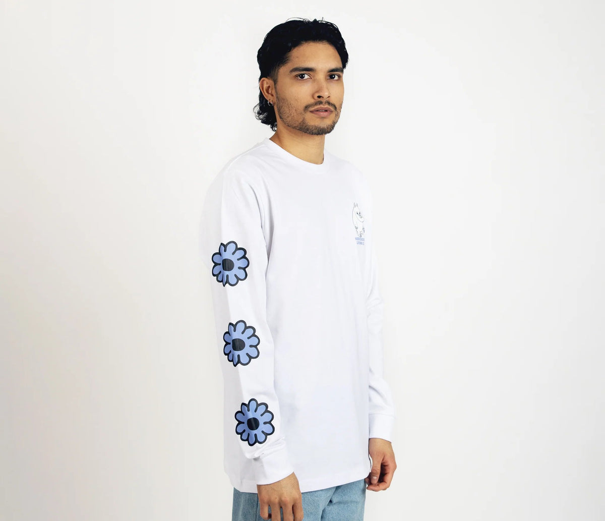 3. Unisex white Moomintroll's Flower longsleeve shirt worn by male model, side view highlighting blue floral sleeve design and cuffrib
