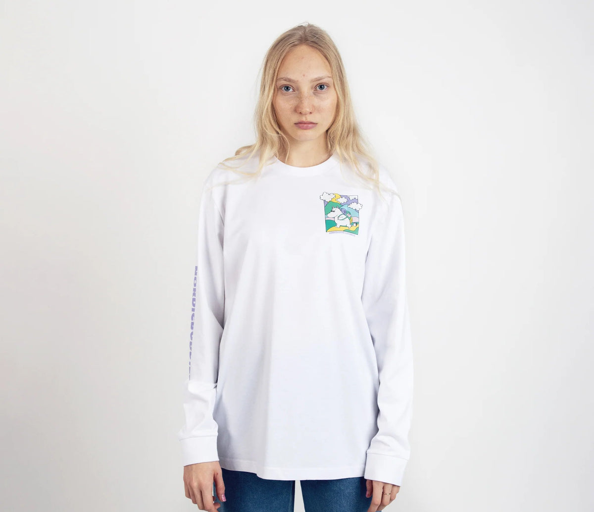 1. Unisex white Moomintroll's Adventure longsleeve shirt worn by female model, featuring colorful chest graphic and NordicBuddies branding on sleeve