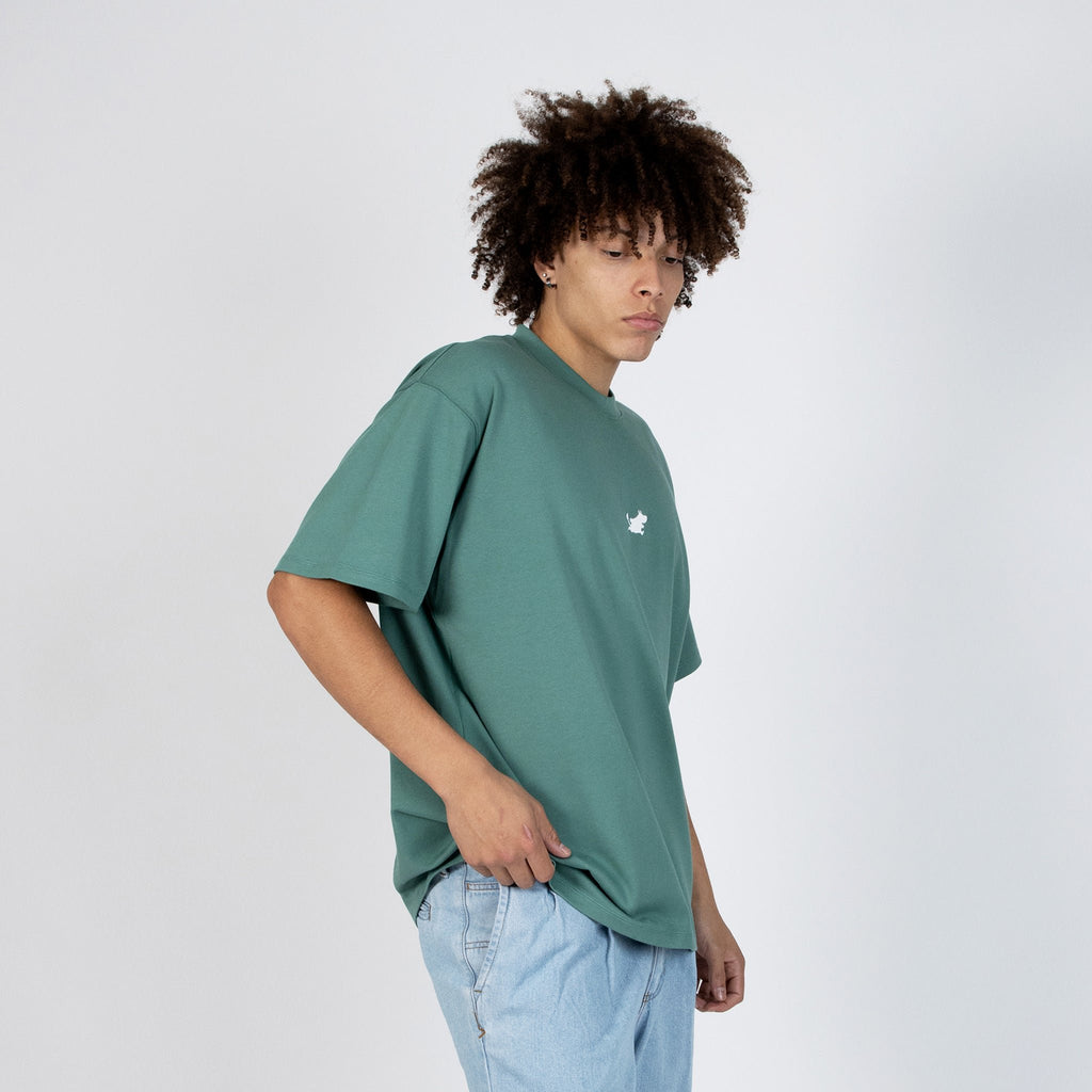 2. Men's green Moomin Classics heavy t-shirt styled with light denim, shown in side view