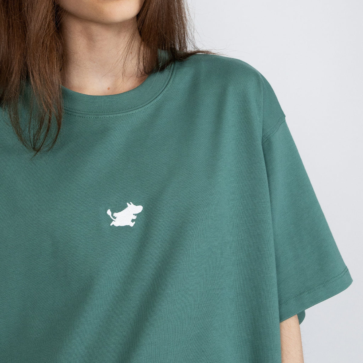 4. Close-up of women's green Moomin Classics heavy t-shirt with white Moomin logo