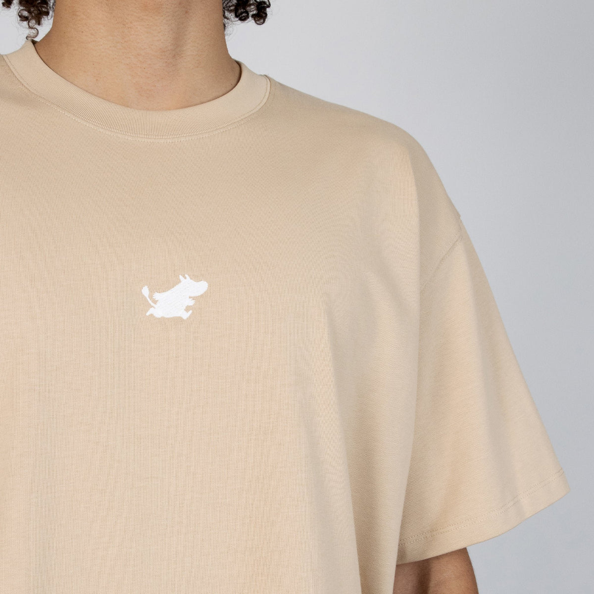 5. Close-up of Moomin logo on beige cotton fabric of heavy t-shirt