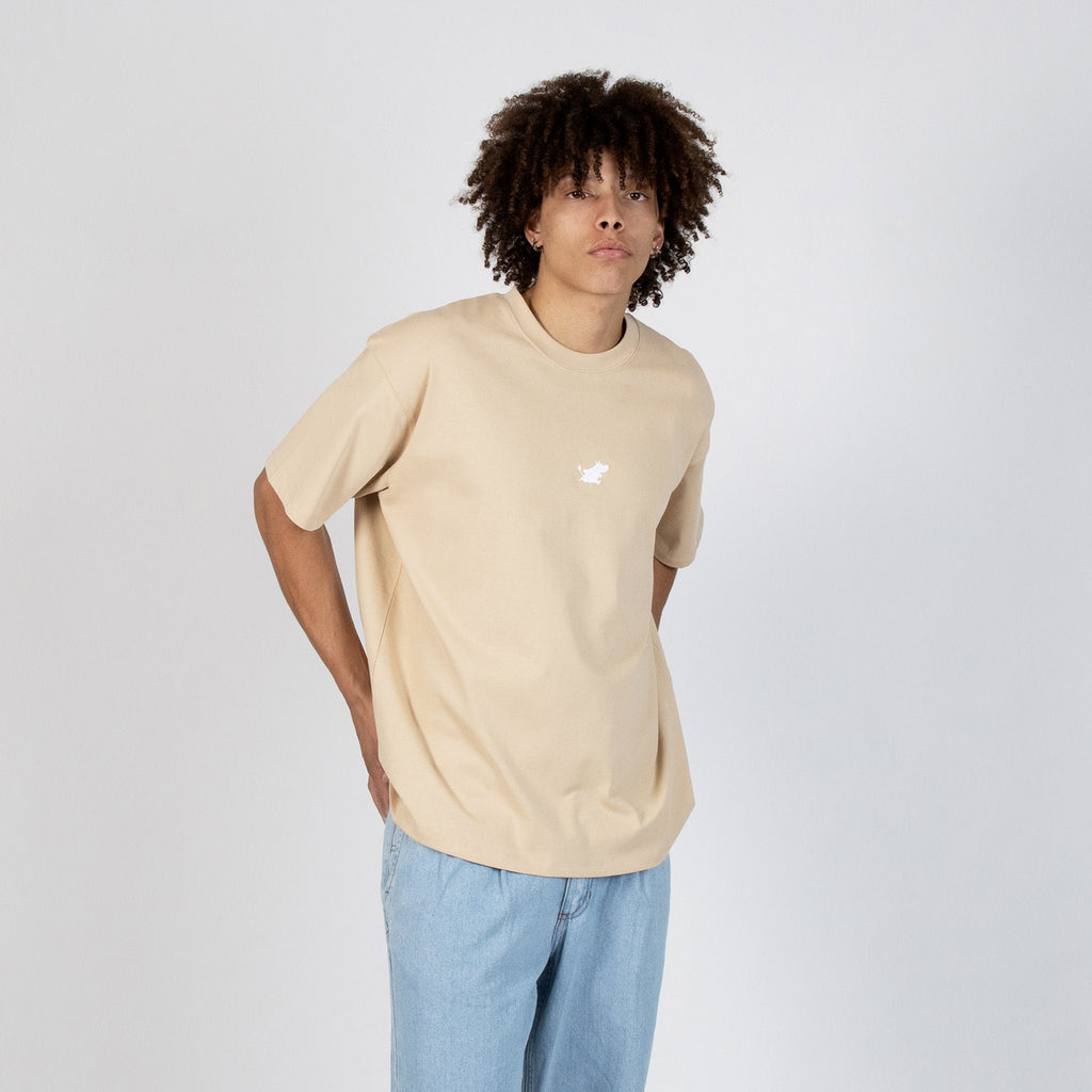 3. Men's beige Moomin Classics heavy t-shirt styled with light denim, shown in front view