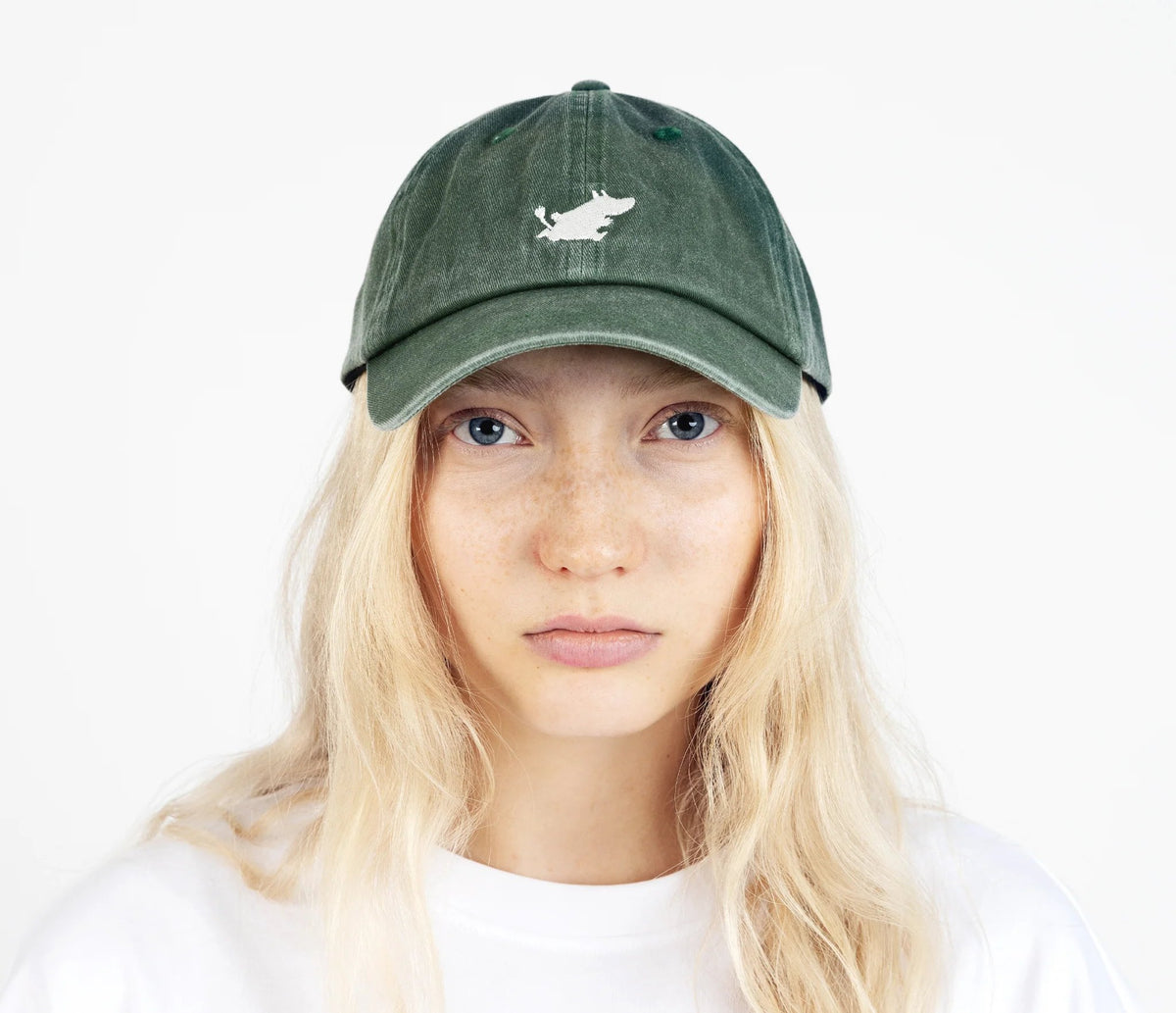 1. Woman wearing Moomintroll washed denim cap in green by NordicBuddies, front view