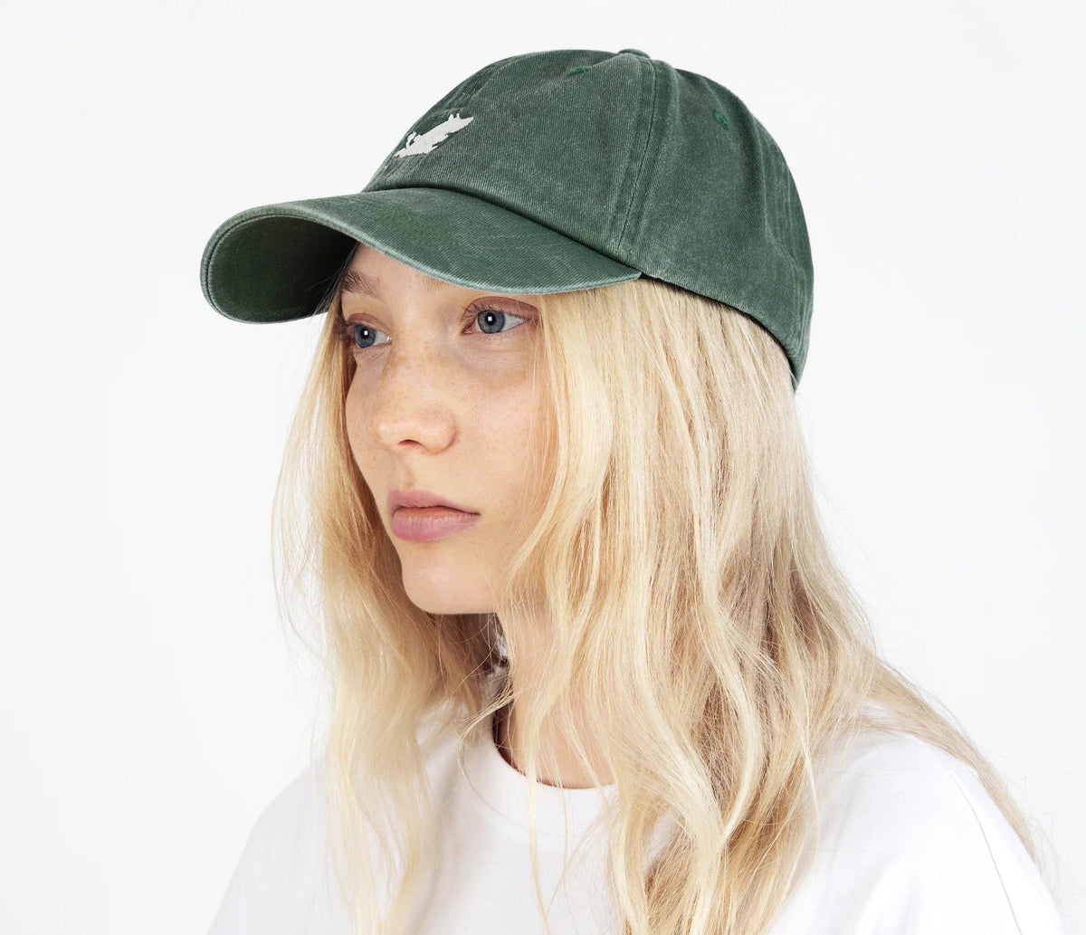 3. Woman wearing Moomintroll washed denim cap in green by NordicBuddies, side view