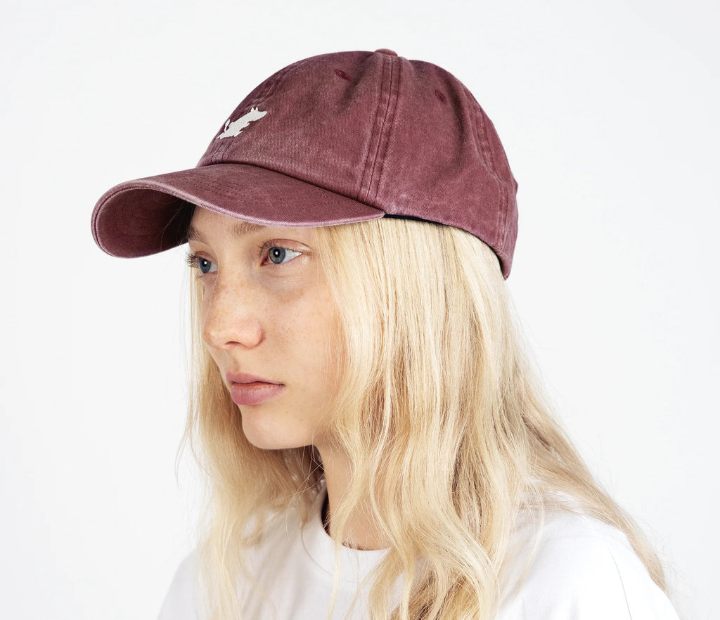 1. Woman wearing Moomintroll washed denim cap in burgundy by NordicBuddies, side view