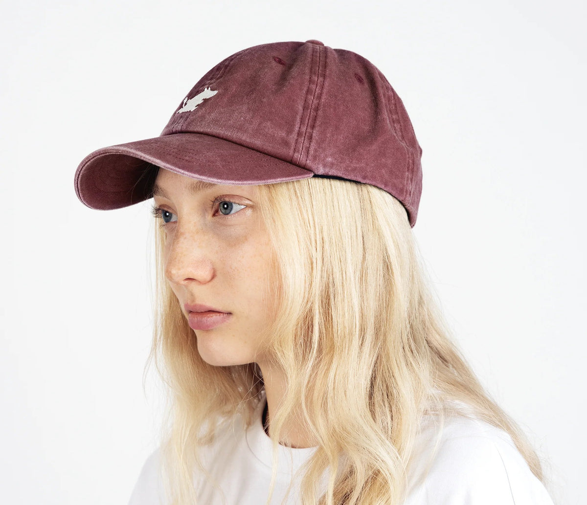 1. Woman wearing Moomintroll washed denim cap in burgundy by NordicBuddies, side view
