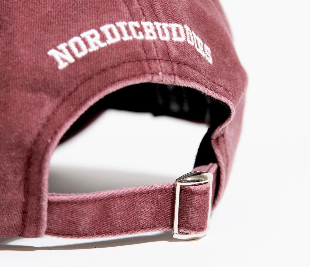 6. Close-up of adjustable strap and NordicBuddies branding on burgundy Moomintroll cap