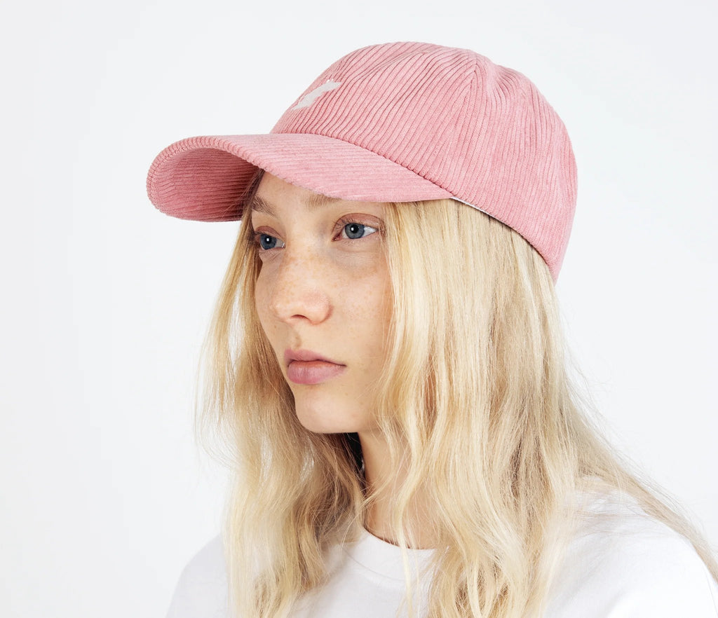 2. Unisex pink Moomintroll corduroy cap worn by female model in studio, side view