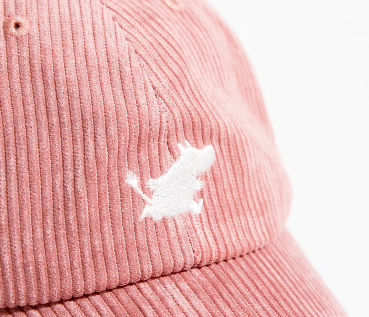 7. Close-up of white Moomintroll logo on pink corduroy fabric