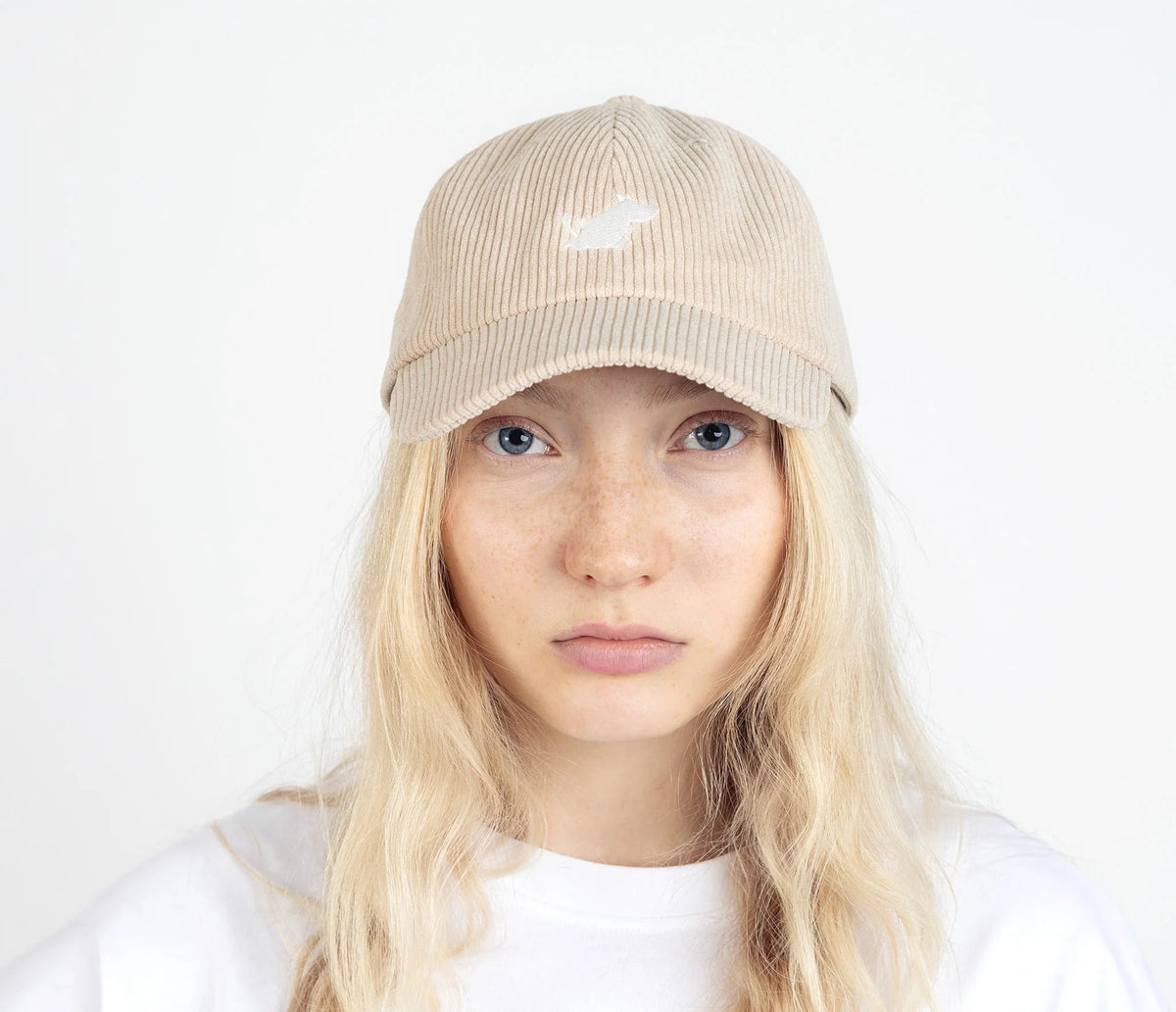 4. Unisex sand Moomintroll corduroy cap worn by female model, front view