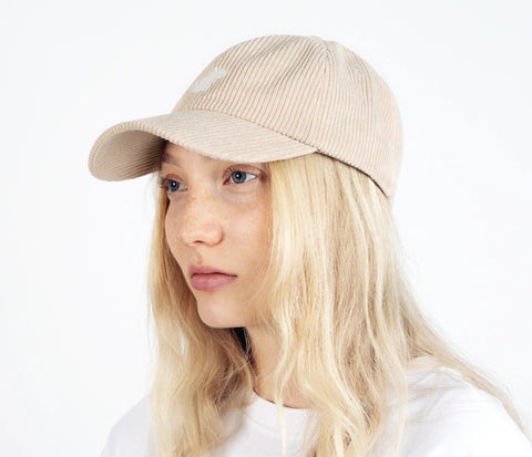 1. Unisex sand Moomintroll corduroy cap worn by female model, showcasing front design