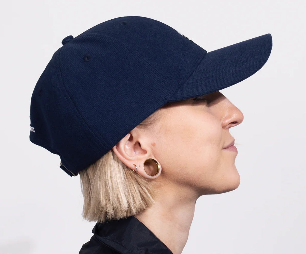 3. Side profile of woman wearing navy Moominpappa corduroy cap by Moomin