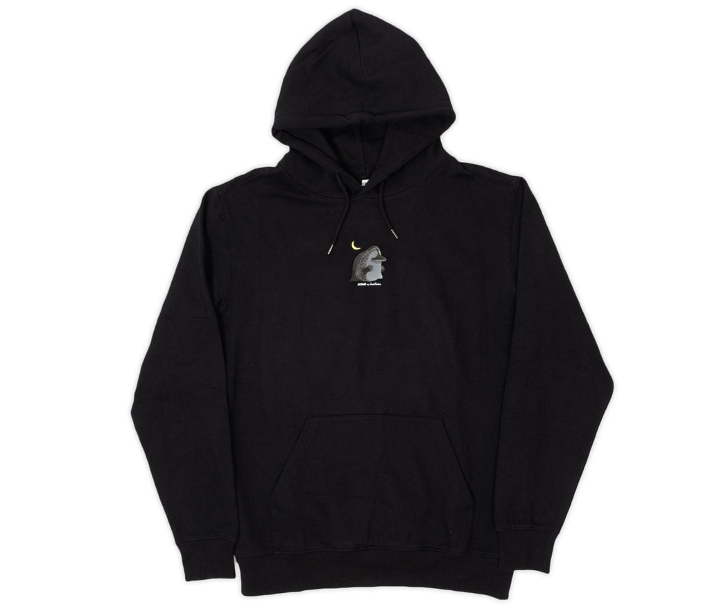 3. Studio image of unisex black Moomin hoodie with minimalistic character detail on chest