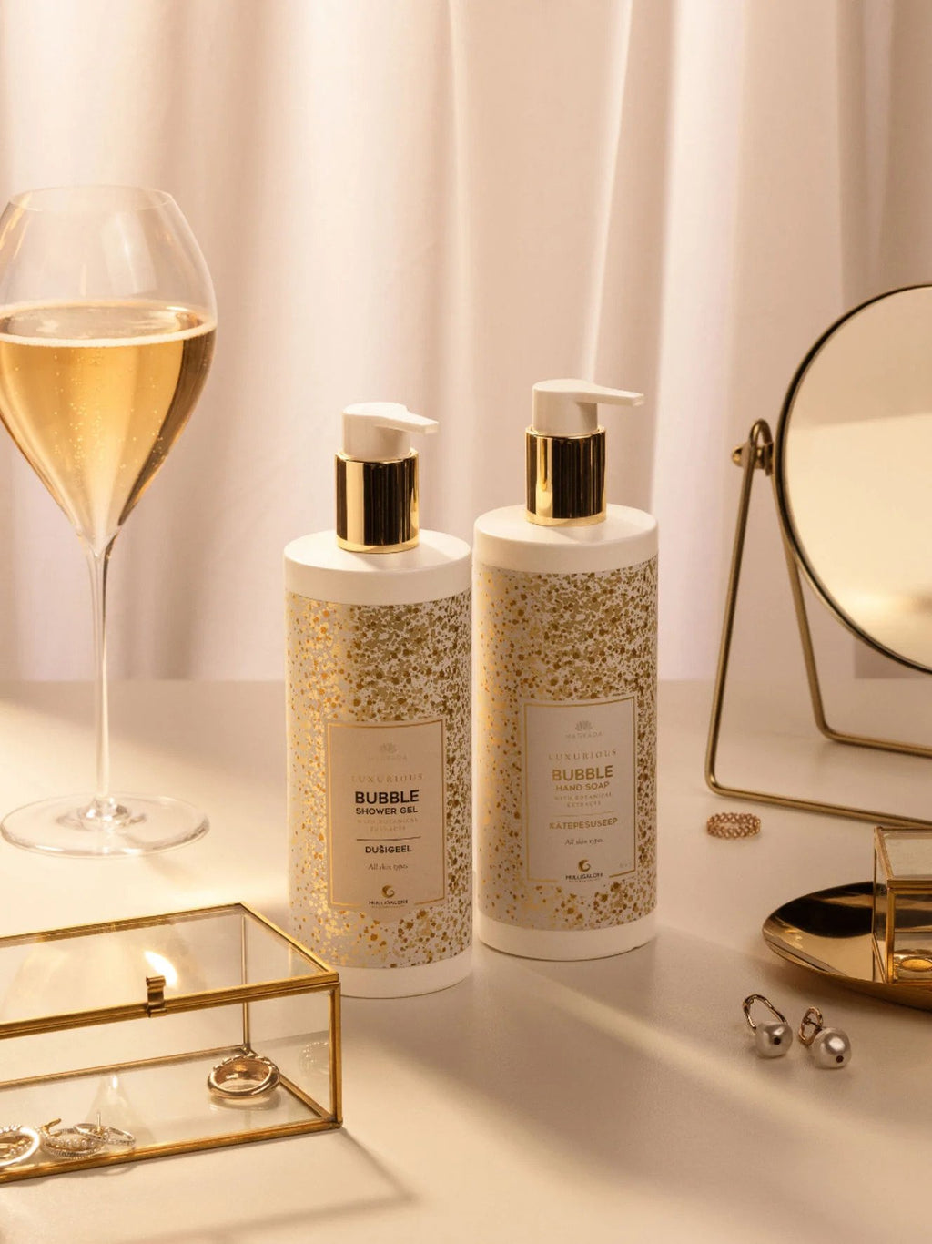 3. Two bottles of Magrada Organic Cosmetics Bubble Hand Wash Gel with jewelry and mirror, showcasing luxury