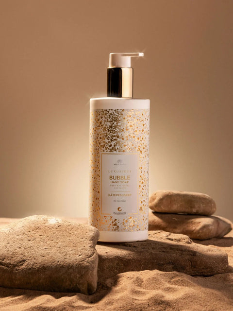 2. Magrada Organic Cosmetics Bubble Hand Wash Gel bottle on sandy surface, highlighting elegant packaging