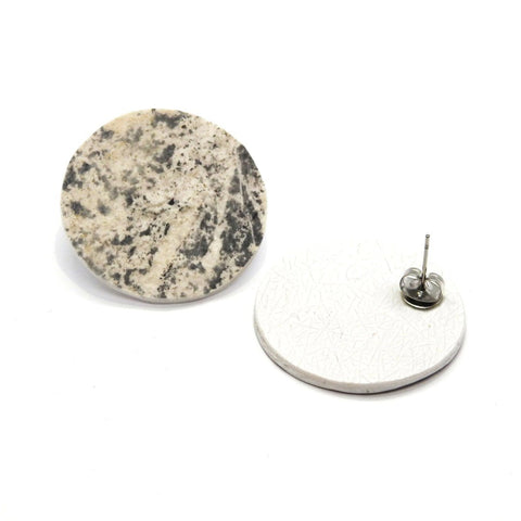 2. Pair of round earrings made from slate and marble with a minimalist design, featuring a speckled black and white pattern, shown on a white background