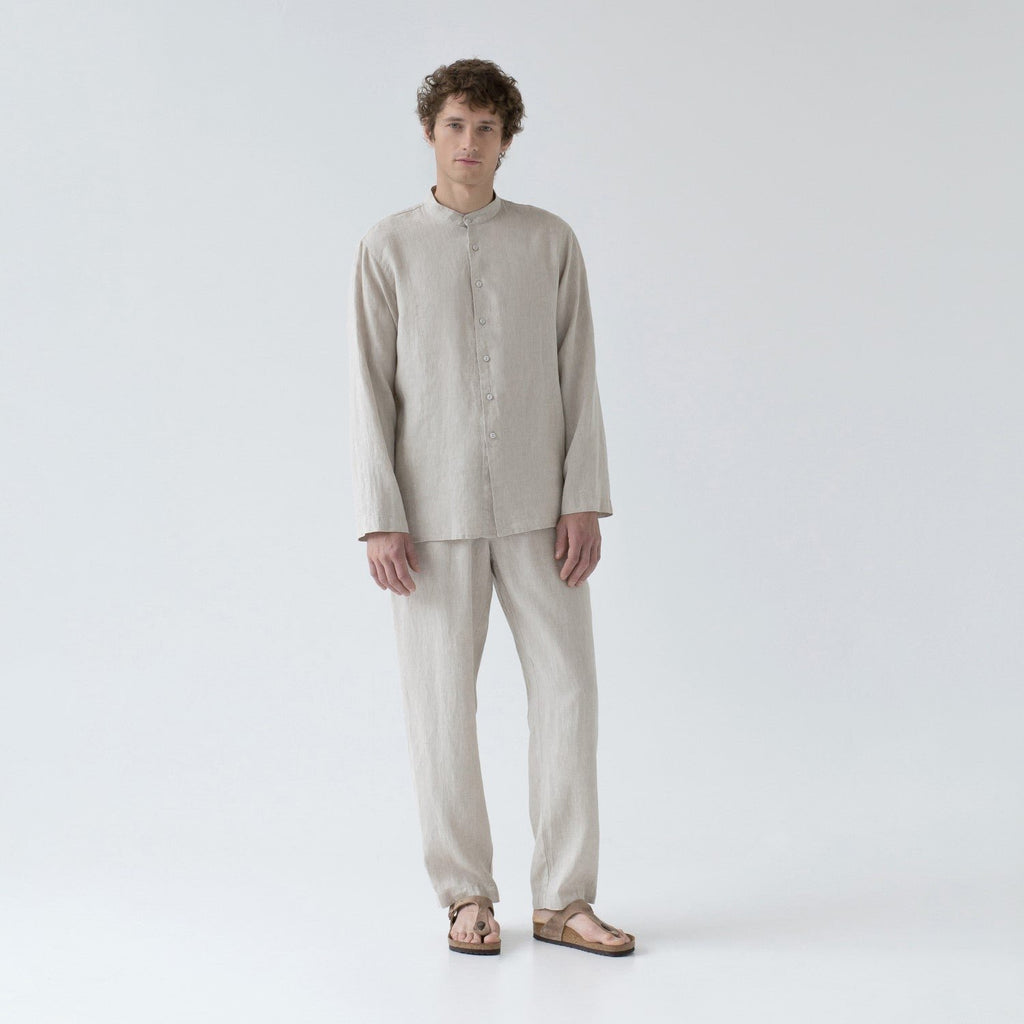 2. Man in beige linen loungewear set with buttoned top and relaxed trousers, standing in studio