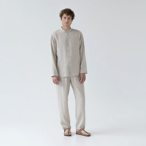 2. Man in beige linen loungewear set with buttoned top and relaxed trousers, standing in studio
