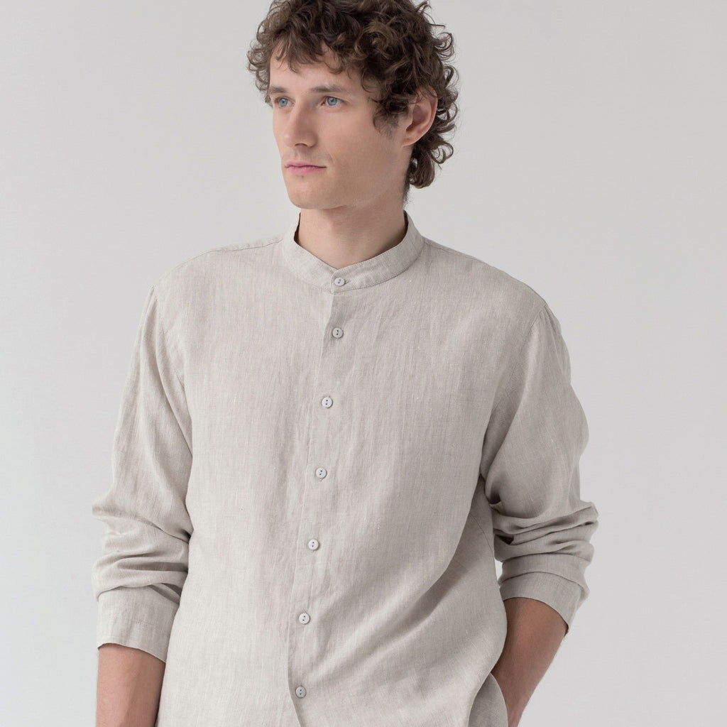 3. Close-up of man in beige linen top with buttoned front and long sleeves, studio background