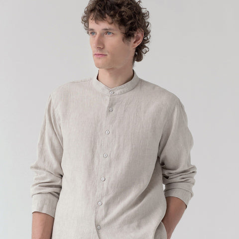 3. Close-up of man in beige linen top with buttoned front and long sleeves, studio background