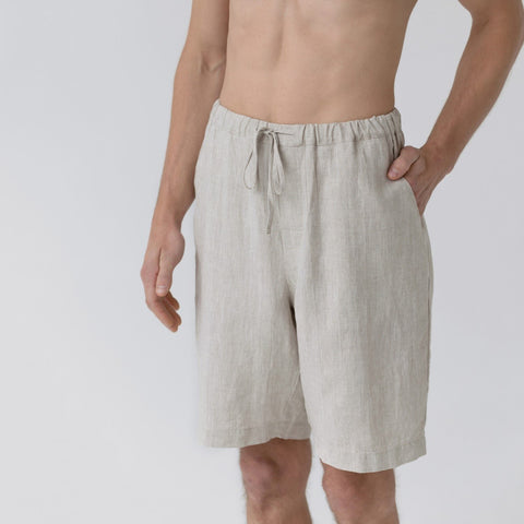 3. Close-up of beige linen pyjama shorts with elasticated waistband and drawstring, shown in studio setting
