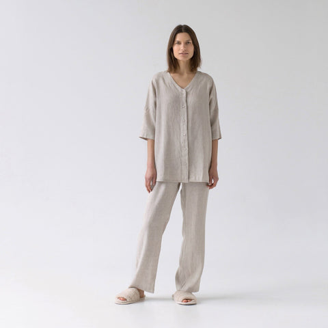 2. Woman wearing melange linen loungewear set with V-neck top and relaxed pants in studio