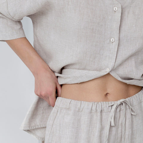 3. Close-up of melange linen loungewear showing buttoned top and drawstring waistband