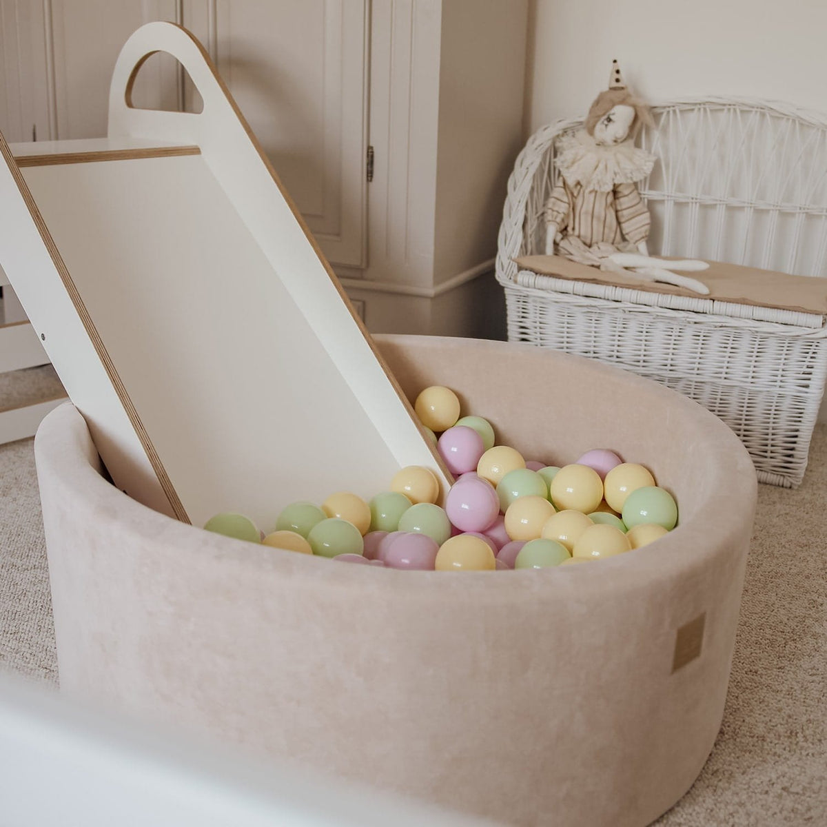 2. Beige MeowBaby foam ball pit with pastel balls and a slide in a nursery setting