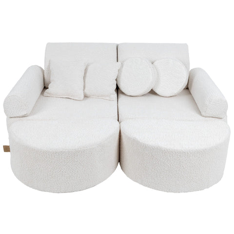 1. Medium modular children's sofa in boucle white with round and square cushions, showcasing versatile design and comfort
