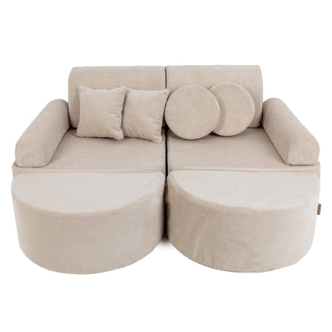 1. Children's modular sofa in ecru slimcord fabric with multiple cushions, shown in a studio setting