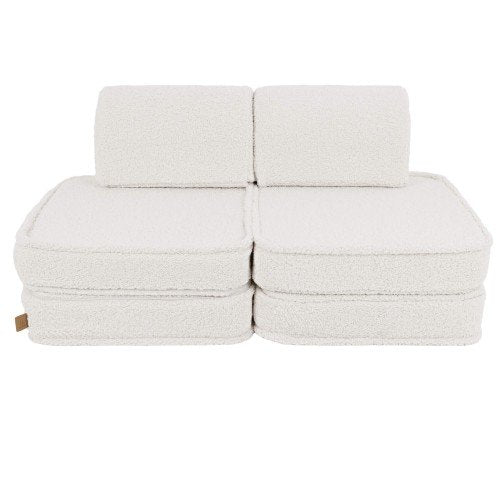 1. Small modular children's sofa in bearly cream color with two back cushions and four seat cushions on a white background