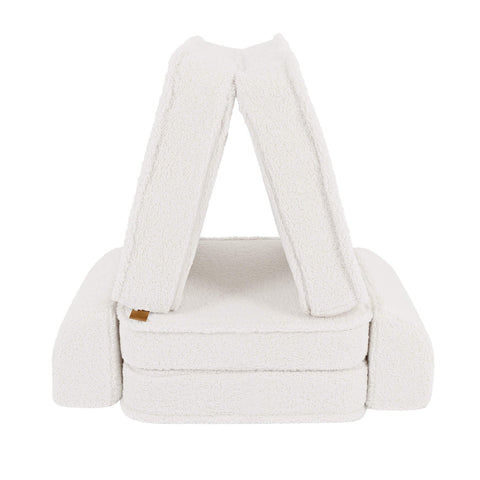 2. Small modular children's sofa in bearly cream color arranged in a tent-like structure on a white background