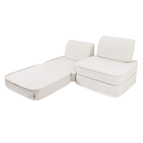 4. Small modular children's sofa in bearly cream color arranged in an L-shape with two back cushions on a white background