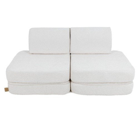 1. Small modular children's sofa in white boucle fabric with two back cushions and two seat cushions on a white background
