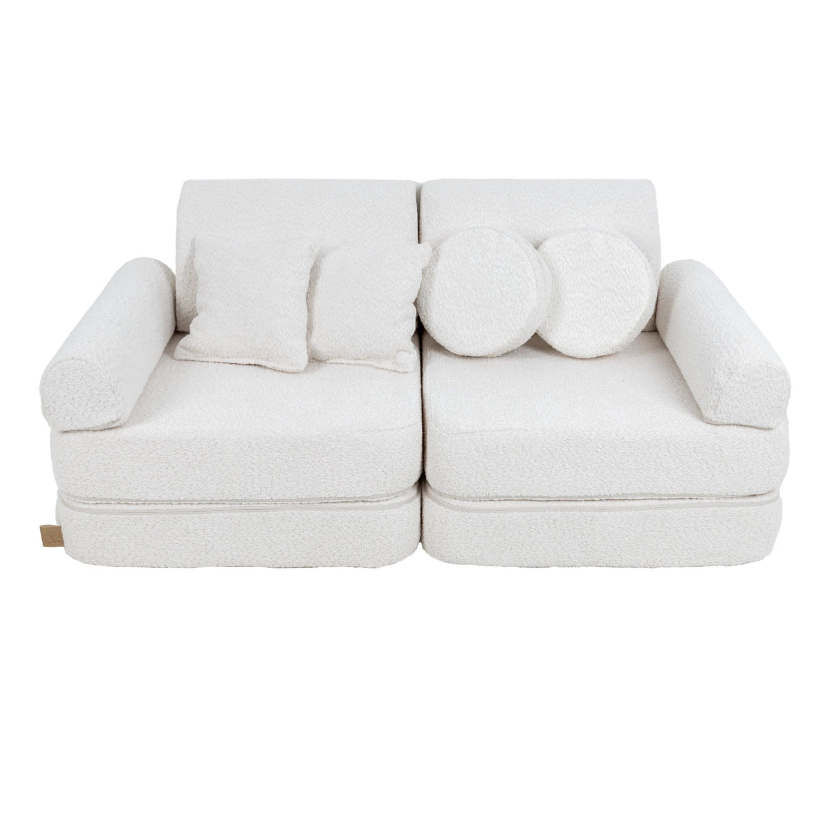 1. Medium modular children's sofa in white boucle fabric with two round and two square cushions, shown in a studio setting