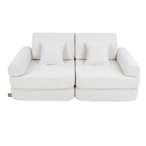 2. Medium modular children's sofa in white boucle fabric with two square cushions, shown in a studio setting
