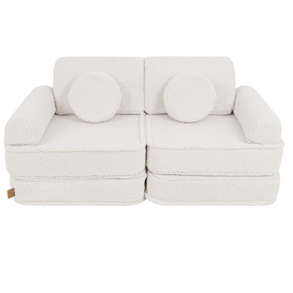 2. Medium modular sofa for kids in bearly cream with two round cushions, shown in a studio setting.
