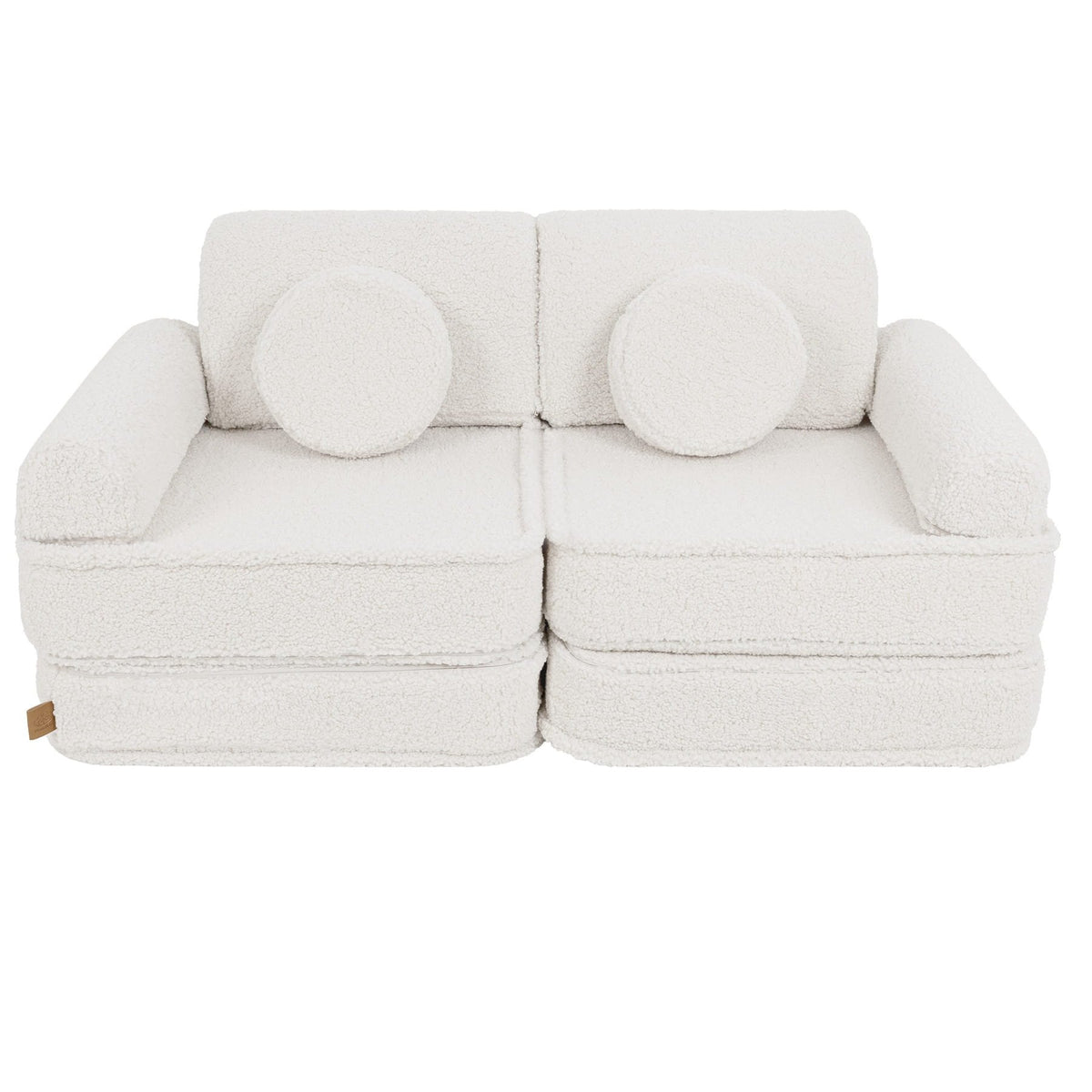 2. Medium modular sofa for kids in bearly cream with two round cushions, shown in a studio setting.