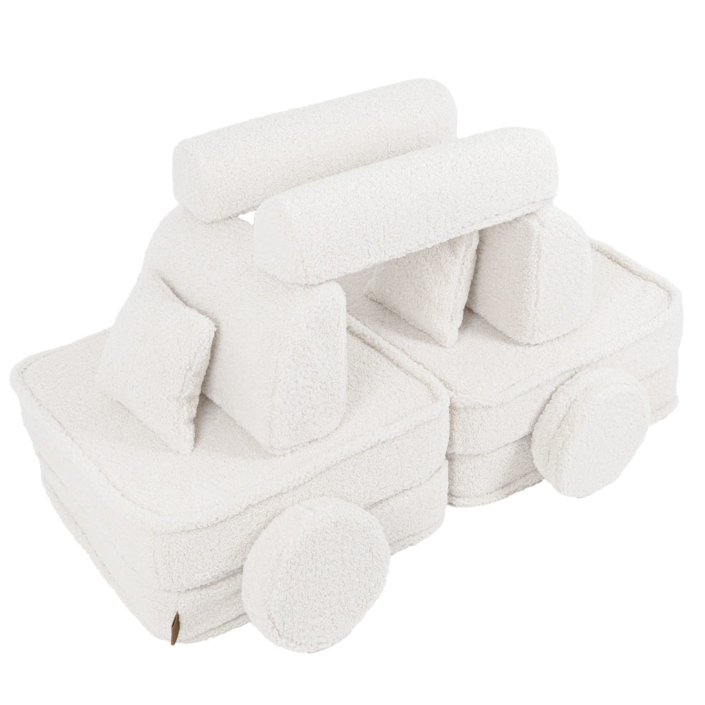 4. Flat lay of medium modular sofa for kids in bearly cream arranged as a creative structure, shown in a studio setting.