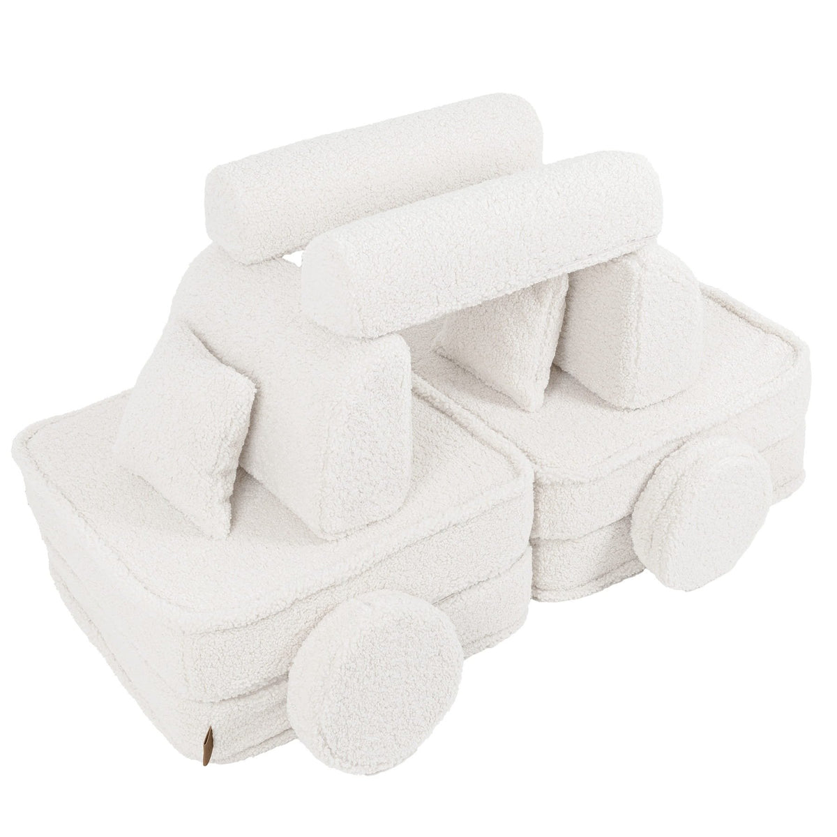 4. Flat lay of medium modular sofa for kids in bearly cream arranged as a creative structure, shown in a studio setting.