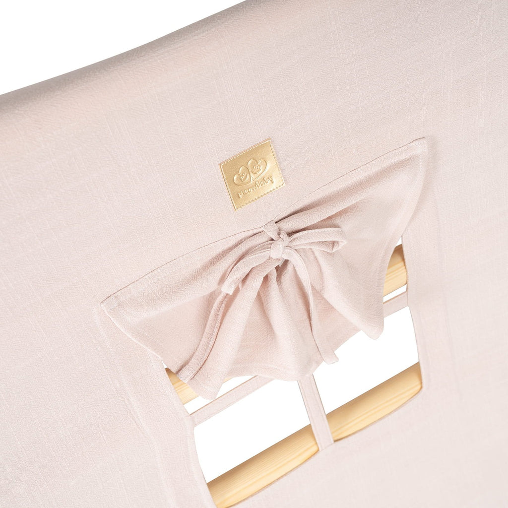 7. Close-up of pink fabric cover with window and bow detail on children's playhouse