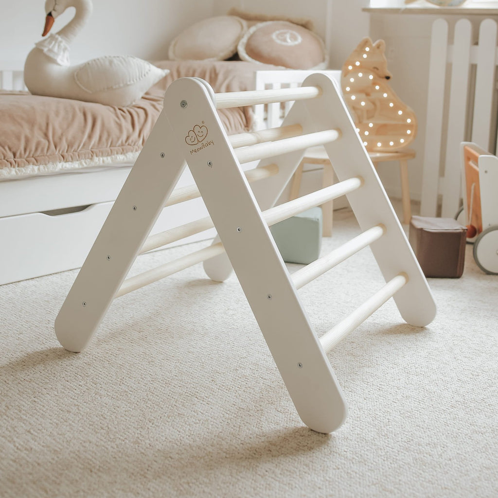4. White wooden Pikler climbing ladder in a child's room with soft lighting and decor