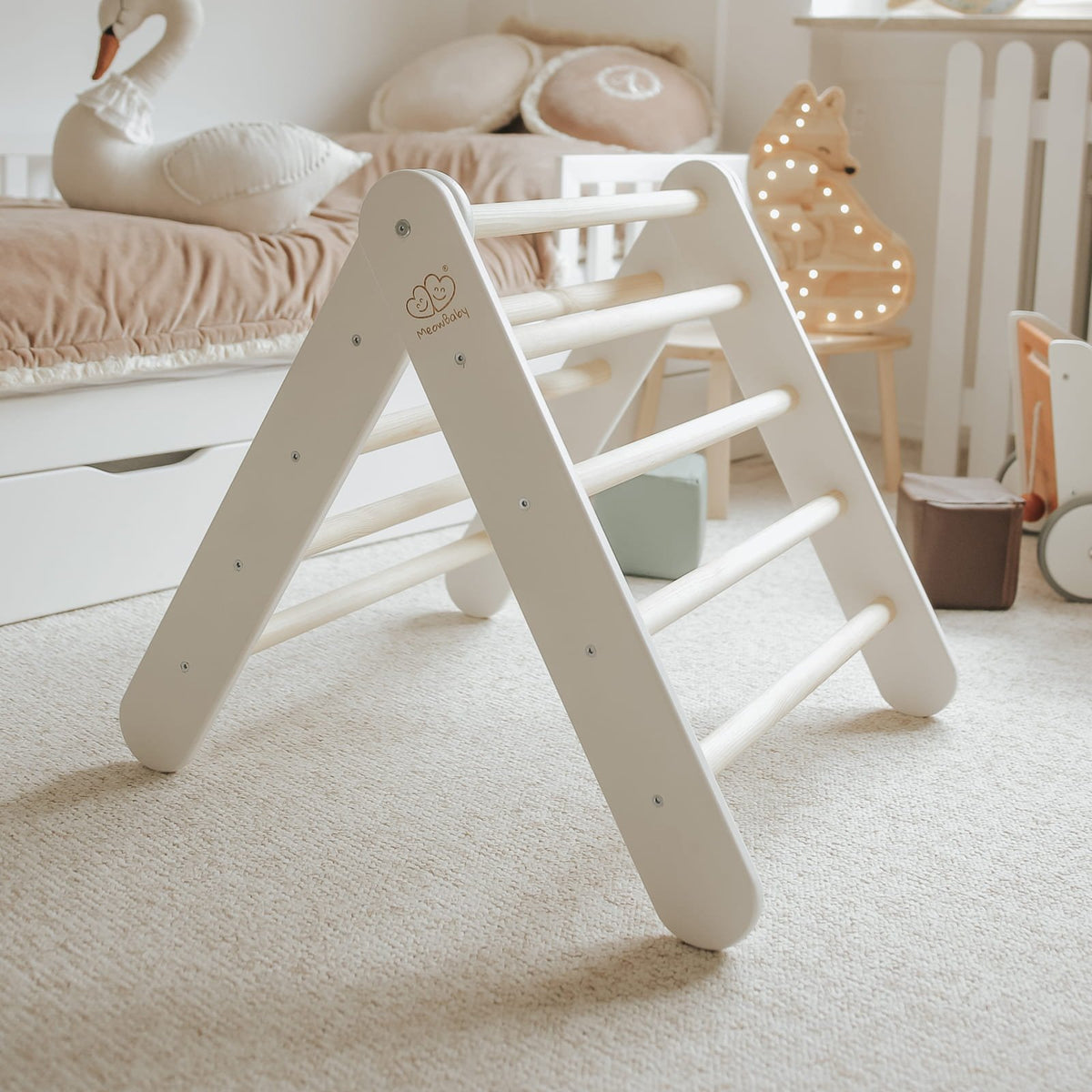 4. White wooden Pikler climbing ladder in a child's room with soft lighting and decor