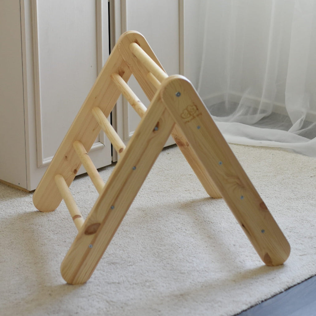 18. Natural wood ladder with slide in a home environment, showcasing its adaptability for indoor play