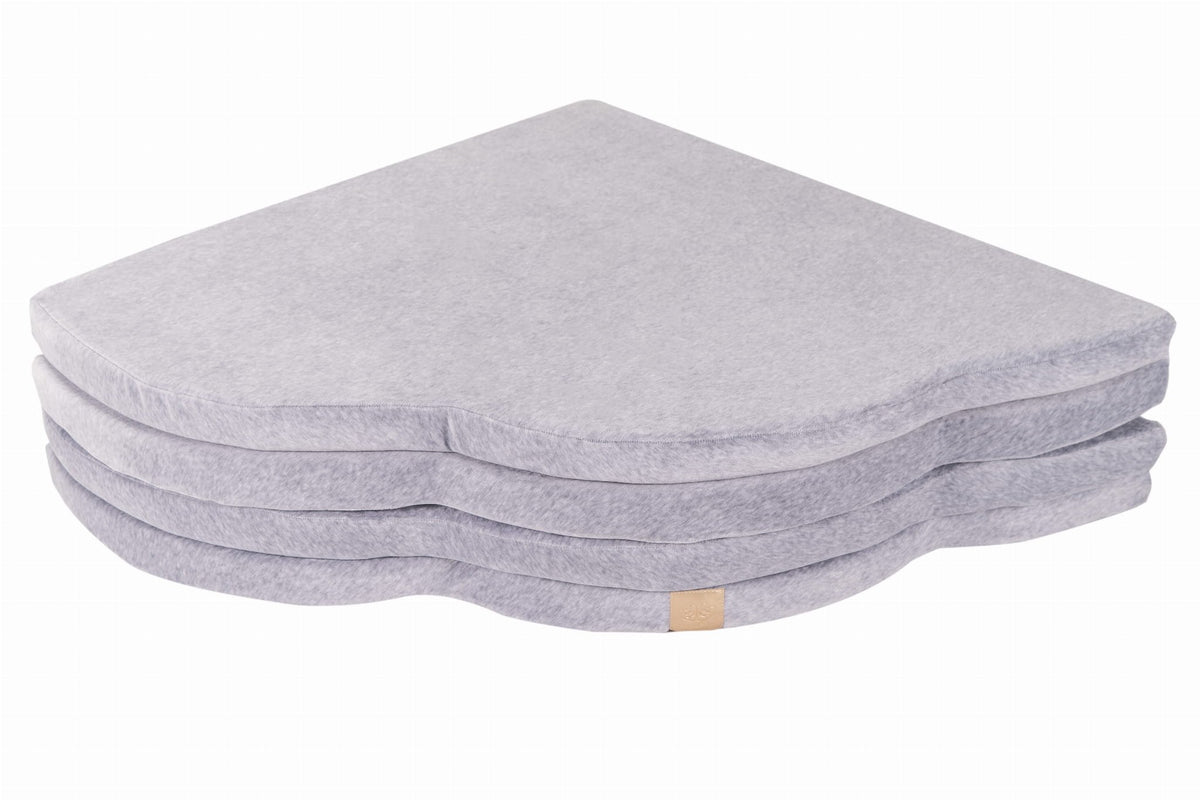 5. Light grey cloud-shaped play mat folded flat in studio setting