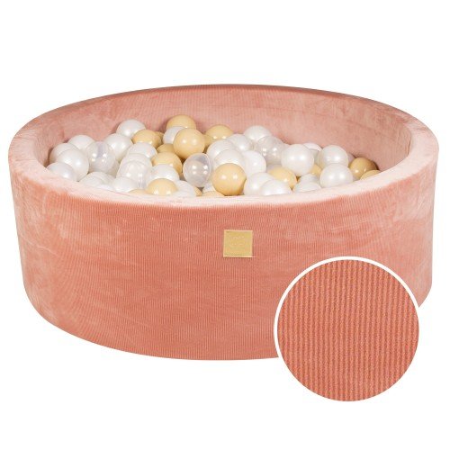 1. Apricot velvet round ball pit filled with white, sand, and translucent balls, featuring soft hypoallergenic foam and machine washable cover, ideal for children's sensory play and motor skill development.