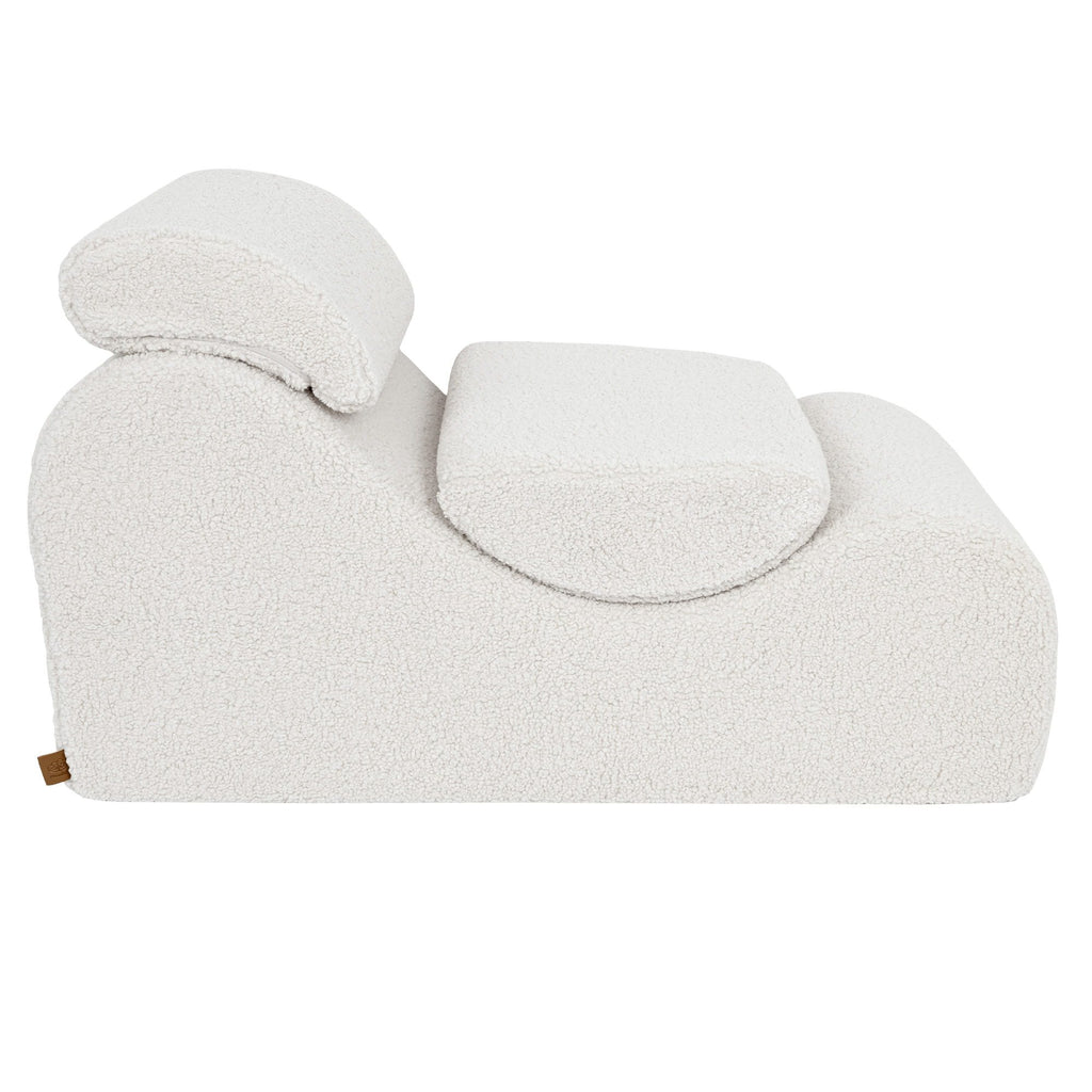 5. Side view of cream Wave Lounger with headrest and seat cushion, emphasizing its ergonomic shape