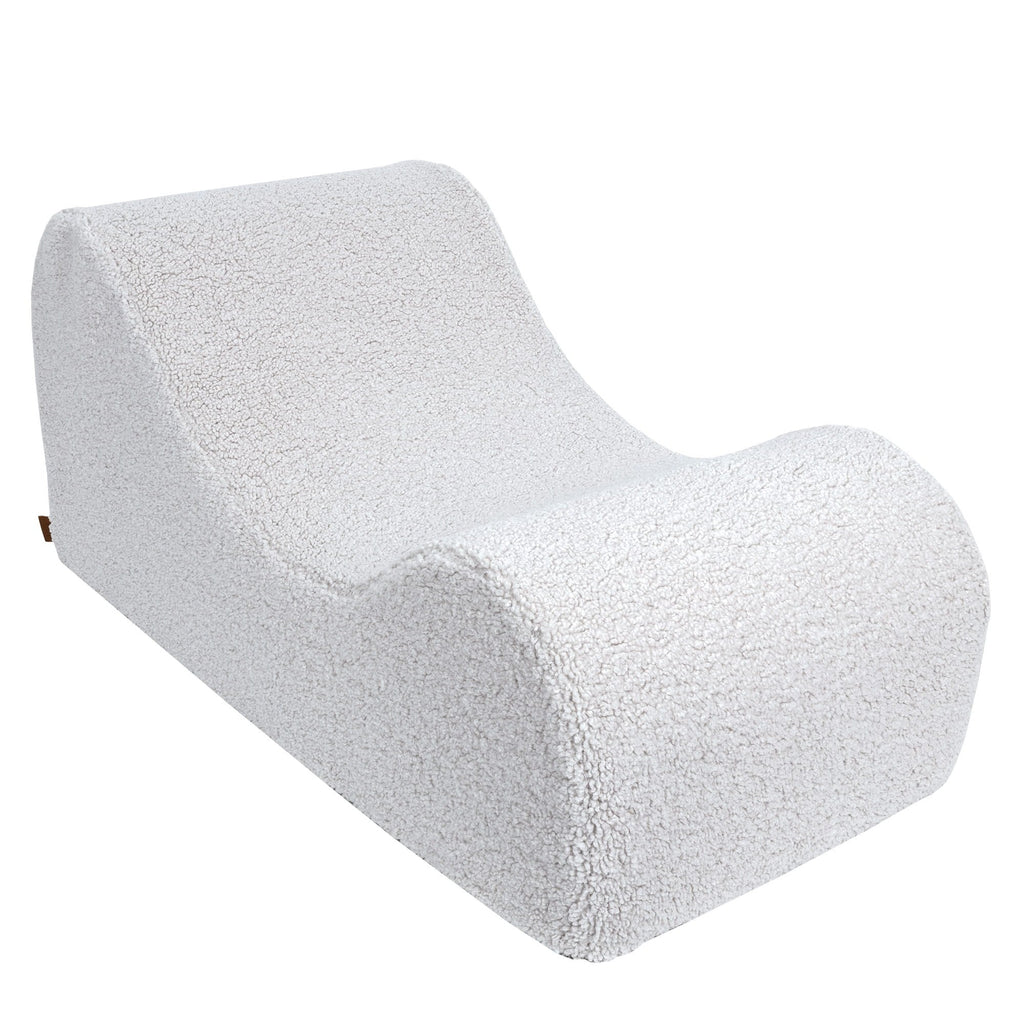 7. White Wave Lounger without headrest, highlighting its minimalist S-shape design in a studio setting